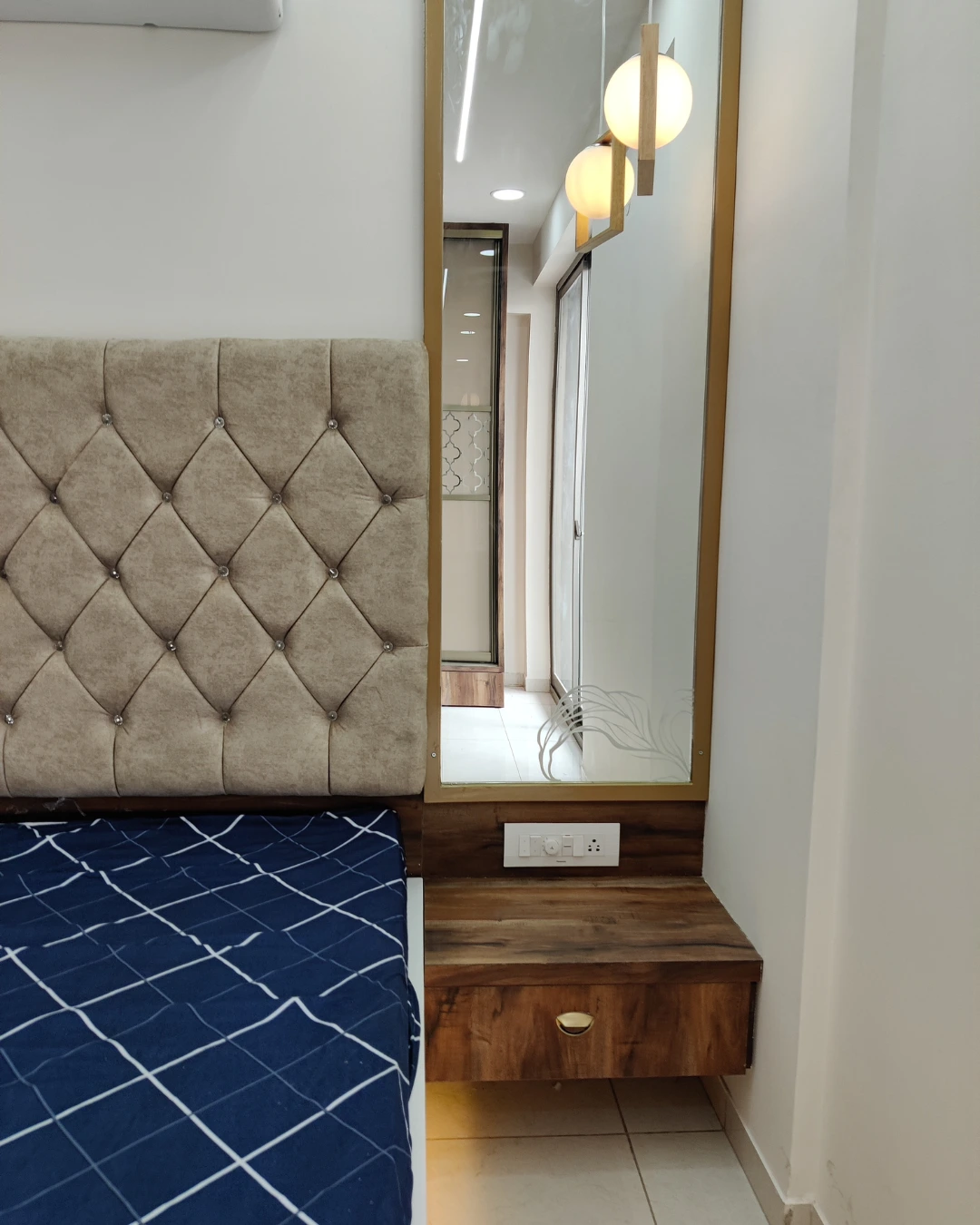 Bedroom with upholstered headboard and warm finishes